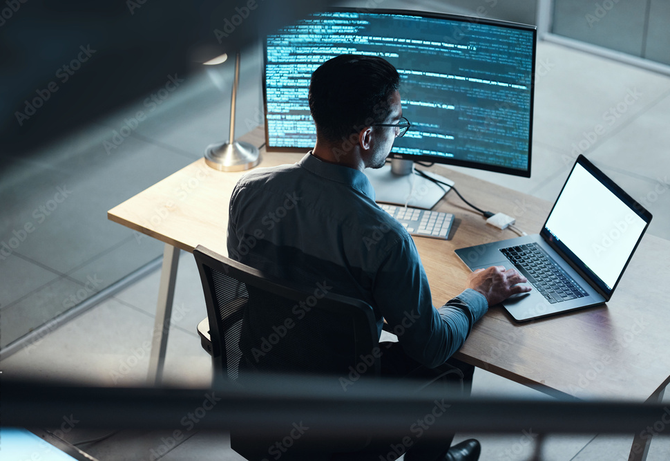 Man, programmer and coding at night on laptop mockup screen for networking, malware or software at the office. Male person, coder or developer working late in computer display in problem solving
