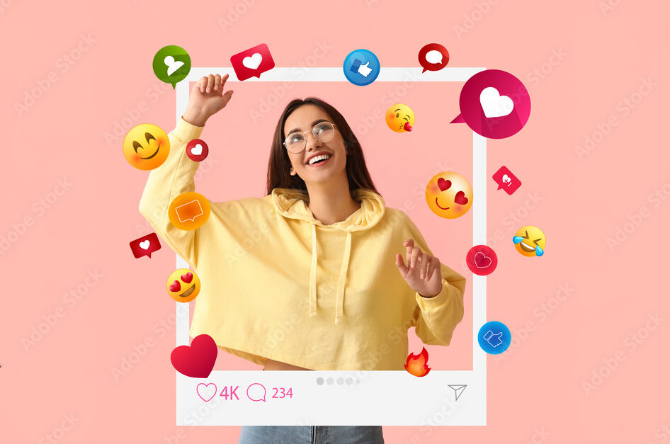 Happy young female blogger on pink background